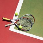 Tennis Racket and Balls on Court