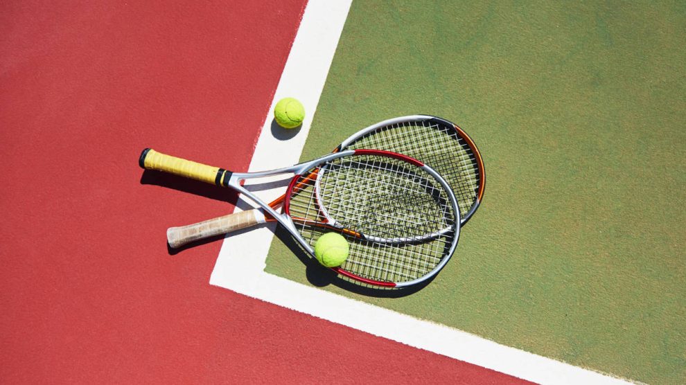 Tennis Racket and Balls on Court